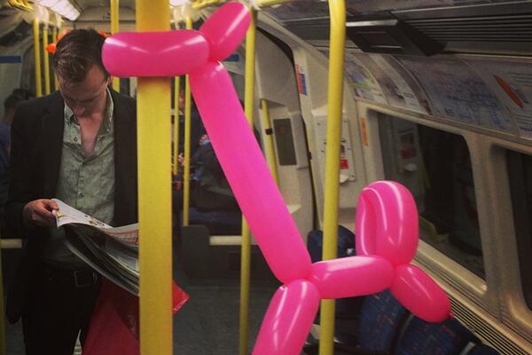 tube balloon tided around subway rail