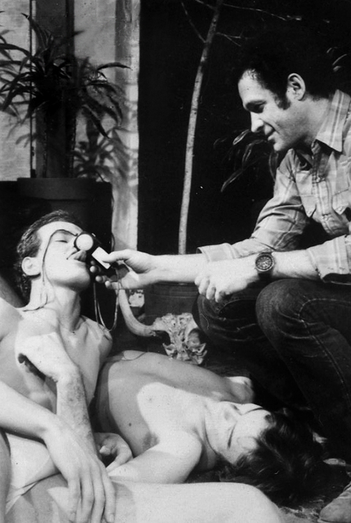 Star Henk van Dijk licking Jack Deveau's light meter on the set of Ballet Down the Highway (1975)