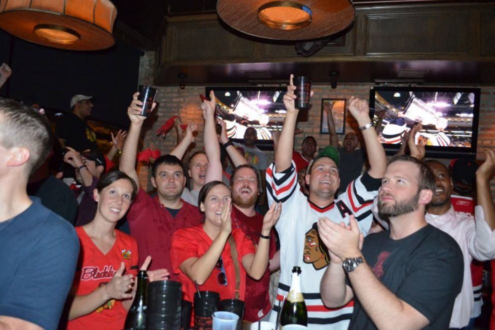 Bros cheering at a sports bar