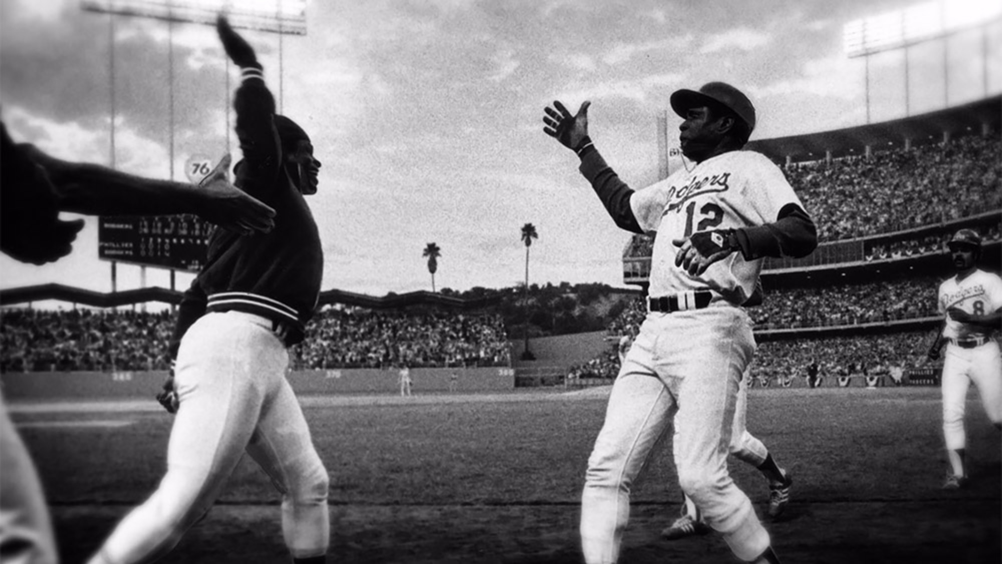 Glenn Burke giving a high five on the baseball field