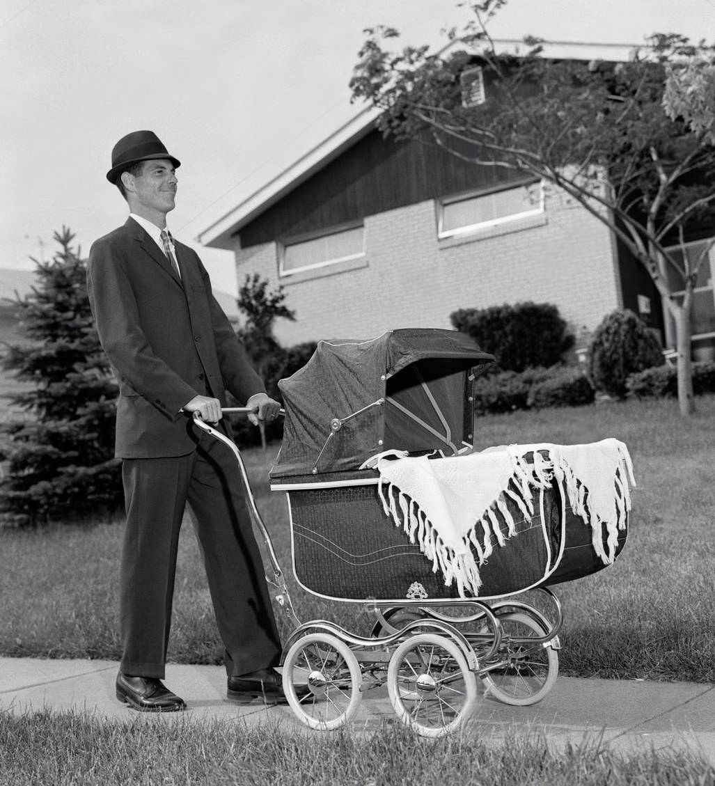 195s man in suit pushing baby carriage