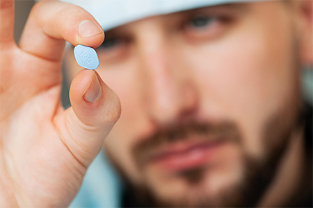 Man holding Viagra pill