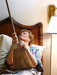 Old lady neighbor banging on ceiling with broom