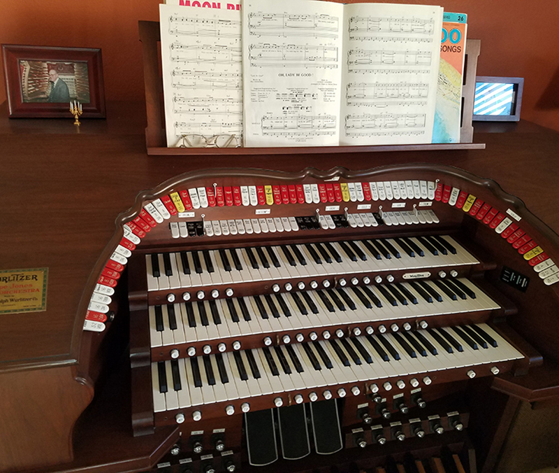 Open close-up with framed picture of organ teacher sitting on it