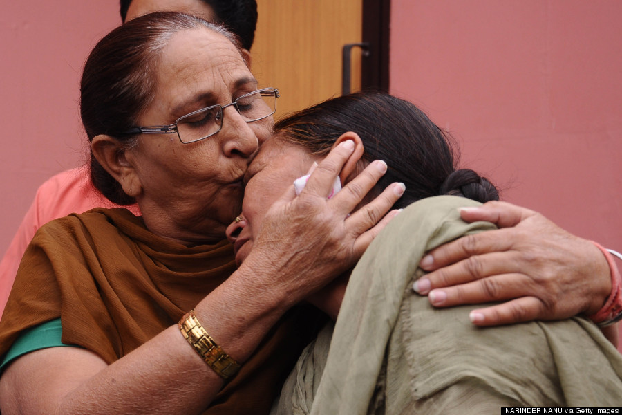 Woman kissing another woman to comfort her