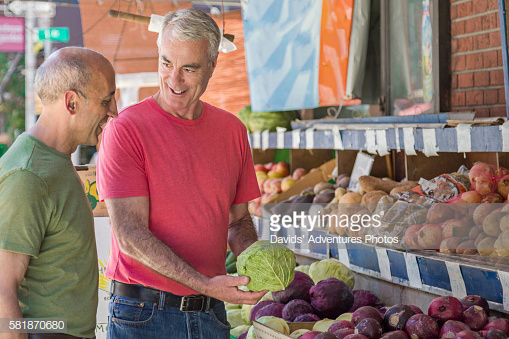 Senior gay couple produce shopping