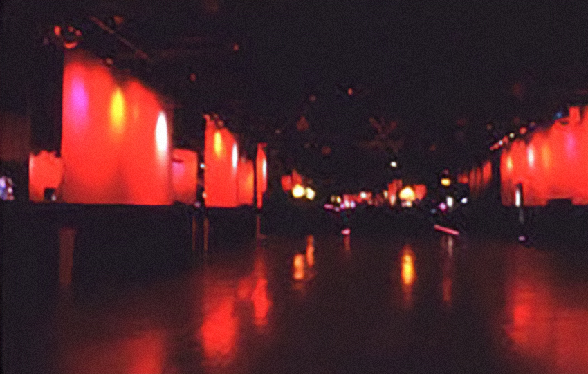 Red-lit panels in a large dark room