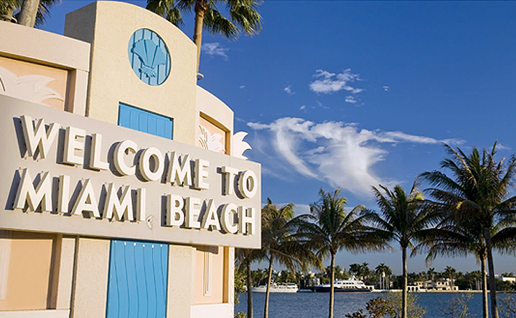 Two angles of an exterior reading Welcome to Miami Beach beside palm trees and an ocean view