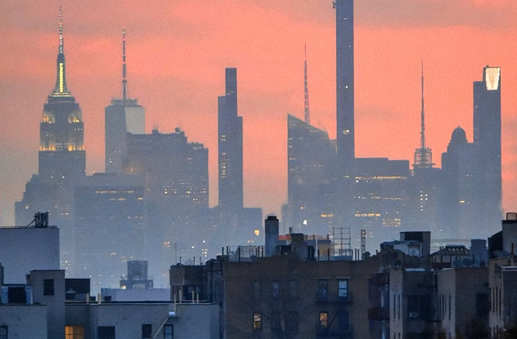 New York City skyline at dawn with pink sky
