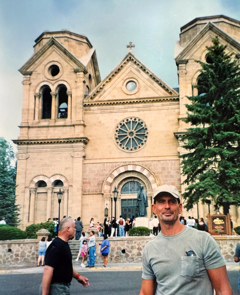 Will posing in front of the crowded exterior of the Basilica of St. Francis