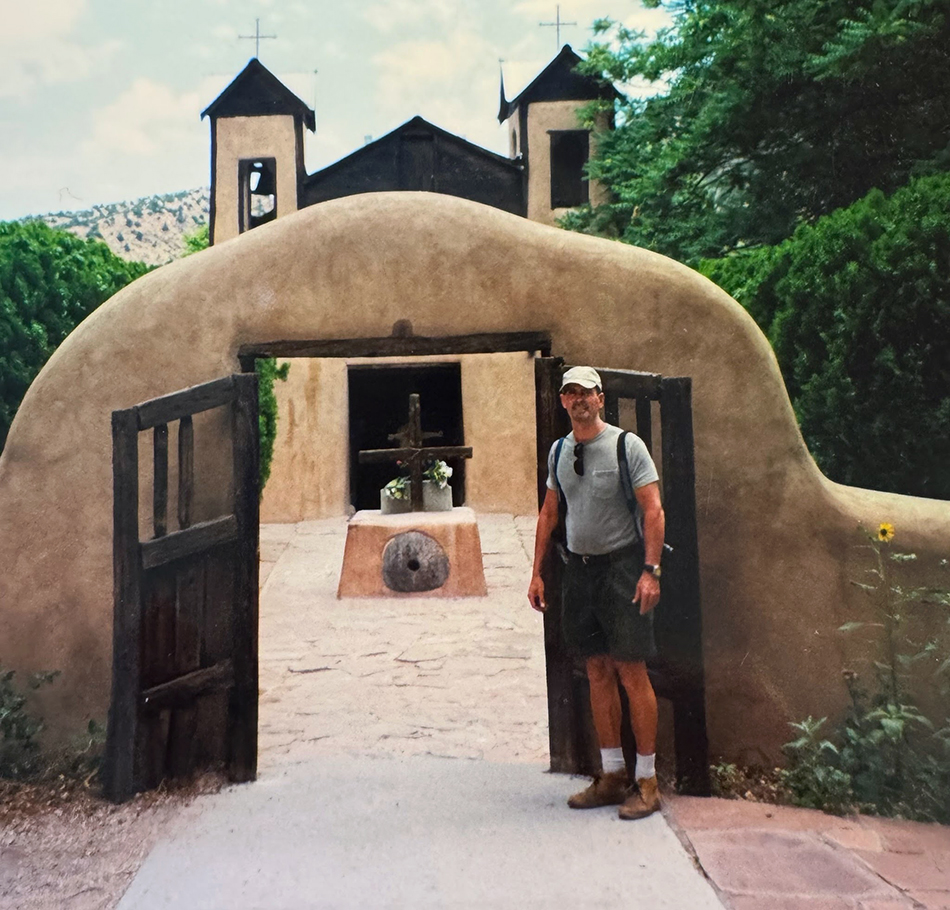 Will in front of an old adobe church